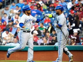 Toronto Blue Jays first baseman Edwin Encarnacion (left) celebrates with with designated hitter Juan Francisco after hitting a home run against the Philadelphia Phillies at Citizens Bank Park in Philadelphia, May 6, 2014. (ERIC HARTLINE/USA Today)