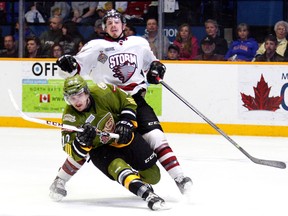 GORD YOUNG/The Nugget/QMI AgencyNorth Bay Battalion forward Vincent Praplan fights off Guelph Storm forward Scott Kosmachuk during Game 3 of the OHL finals Tuesday, May 6, 2014, at Memorial Gardens in North Bay, Ont. The Storm won 4-3 on a pair of goals in the final minute.