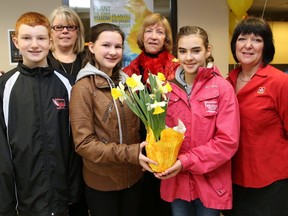 JOHN LAPPA/THE SUDBURY STAR/QMI AGENCY 
Carl A. Nesbitt Public School students Andrew Simser, left, Riley Banks, and Silvanna Vitiello, and Greater Sudbury city councillor Joscelyne Landry-Altmann, second left, volunteer Arthemise Camirand-Peterson and Brigette Michel, representing Sudbury and area Home Hardware stores, were on hand for the launch of the Daffodils for Hope Sudbury campaign recently. The campaign is in support of the Canadian Cancer Society. Net proceeds from the sale of daffodil bulbs at local Home Hardware locations in the fall of 2014 will be donated to the Wheels of Hope program at the Canadian Cancer Society in Greater Sudbury. The program provides rides to cancer patients being treated in the Sudbury area. The Sudbury Credit Union made a $1,000 donation to the Canadian Cancer Society at the launch.