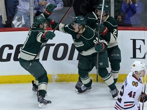 Minnesota Wild forward Mikael Granlund, centre, celebrates his goal with forward Zach Parise, left, and defenceman Jonas Brodin during the third period in Game 3 against the Chicago Blackhawks at Xcel Energy Center. (Brace Hemmelgarn-USA TODAY Sports)