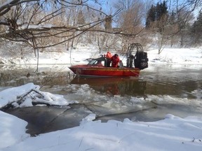 Emergency personnel search for the body of a five-year-old boy from the Nith River in New Hamburg. (QMI Agency File Photo)