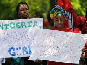 Protesters hold signs during a march in support of the girls kidnapped by members of Boko Haram in front of the Nigerian Embassy in Washington May 6, 2014. (REUTERS/Gary Cameron)