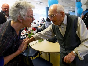 Bruce MacLean, retired University of Toronto mathematics professor gives a rose to Kathy Bodden as he celebrates his 103rd birthday at Evangel Hall Mission on May 7, 2014. (Dave Abel/Toronto Sun)