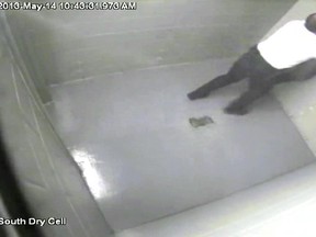 A still image from a surveillance video showing court officer Craig Pickering and Timothy Van Dusen.