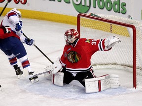 The Edmonton Oil Kings' Luke Bertolucci buries the puck Portland Winterhawks goalie Corbin Boes off a break-in during the second periodof Game 3 of the WHL Final at Rexall Place, in Edmonton Alta., on Tuesday May 6, 2014. David Bloom/Edmonton Sun/QMI Agency