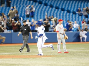 Edwin Encarnacion connects for a three-run homer in the seventh inning in which the Jays scored nine runs. Jays vs. Phillies at the Rogers Centre on May 7, 2014. (Jack Boland/Toronto Sun/QMI Agency)