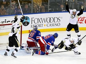 Pittsburgh Penguins centre Evgeni Malkin (bottom right) celebrates scoring a goal against New York Rangers goalie Henrik Lundqvist during Game 4 of their Eastern Conference semifinal series at Madison Square Garden in New York, May 7, 2014. (ADAM HUNGER/USA Today)