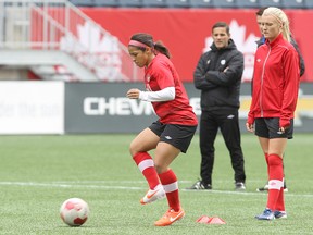 National women's soccer team midfielder Desiree Scott of Winnipeg  goes through a drill as midfielder Kalyn Kyle (right) looks on during practice at Investors Group Field in Winnipeg, Man., on Wed., May 7, 2014. Canada faces the United States in a friendly on Thu., May 8. Kevin King/Winnipeg Sun/QMI Agency