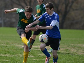 Mike Lindensmith of the Loyalist Lancers kicks the ball away from Vincent Legault of the Marie-Rivier Dragons during a Kingston Area senior boys soccer game at Loyalist Collegiate on Wednesday. The Lancers wo 4-0. (Justin Greaves/For The Whig-Standard)