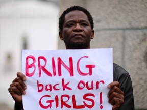 A protester holds a sign during a march in support of the girls kidnapped in Nigeria by members of Boko Haram, in Cape Town May 8, 2014. Nigerian President Goodluck Jonathan pledged on Thursday to find more than 200 schoolgirls abducted by the Islamist rebels, saying their rescue would mark "the beginning of the end of terrorism" in the country. REUTERS/Sumaya Hisham