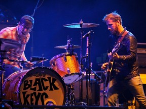 The Black Keys guitarist Dan Auerbach looks over at drummer Patrick Carney  as they play on the main stage at the Coachella Valley Music & Arts Festival in Indio, California April 15, 2011.
 REUTERS/Mike Blake