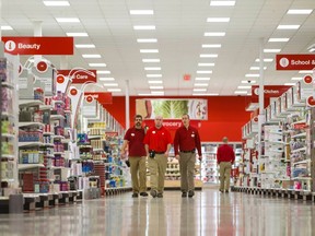 Employees walk through the new Target store on the eve of the store's opening in Guelph, Ontario in this file photo taken March 4, 2013.  (REUTERS/Geoff Robins/Files)