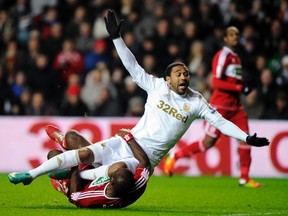 Swansea City's Luke Moore is tackled by Middlesbrough's Andre Bikey during their English League Cup soccer match at the Liberty Stadium in Swansea, South Wales, December 12, 2012. REUTERS/Rebecca Naden