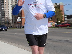 Toronto Police officer Andrew Rosbrook in Kingston on Thursday May 8 2014 on his 470-kilometre marathon from Ottawa to Toronto to raise awareness for accessible defibrillators.  
IAN MACALPINE /KINGSTON WHIG-STANDARD/QMI AGENCY