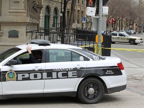 Police cars sit outside Opera Ultralounge on Main Street at Bannatyne Avenue in downtown Winnipeg, Man., on Sunday, May 4, 2014. Police say one man was shot and killed outside the nightclub early Sunday morning. Kevin King/Winnipeg Sun/QMI Agency