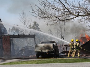 A fire on Unity Road, west of County Rd. 38, destroyed a garage and damaged a house on Thursday afternoon. Julia McKay was on the scene to capture the final stages of the effort by firefighters.