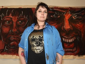 Arlea Ashcroft is seen with paintings representing two of the five stages of grief at Zsa Zsa Gallery in Chinatown on Thu., May 8, 2014. Her art show Let it Burn, dealing with issues of grief, depression and suicide, opens Friday and runs through June 7. Kevin King/Winnipeg Sun/QMI Agency