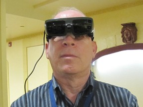 Mike Davidson poses with his eSight digital glasses. The legally blind Chatham man can, in some ways, now see better than people who are normally sighted.