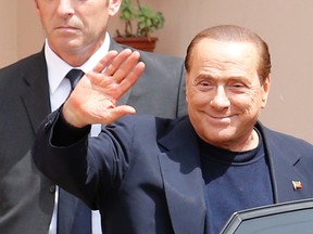 Former Italian Prime Minister Silvio Berlusconi waves as he leaves the Sacred Family Foundation in Cesano Boscone, a small town on the outskirts of Milan.

REUTERS/Stefano Rellandini