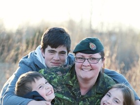 Photo is of  MCpl Jessica Mann, with (from left) Jakob, 6, Jonathon, 15, and Jorja, 8, and Dereka military mom of two with 3rd Canadian Headquarters in Edmonton.