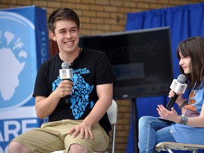 Barefoot Walk co-ordinator Lucas Goodenough and We Create Change Tour member Hannah Alper speak on stage at Victoria Park in London, Ont. May 9, 2014. CHRIS MONTANINI\LONDONER\QMI AGENCY