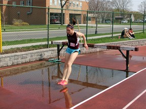 Megan Black of North Lambton gets ready to land in the water pit during the 2nd lap of the LSSAA Open Girl's Steeplechase on Thursday, May 8 at St. Patrick's. Black ran 5:49.42 for the 1500m race. (SHAUN BISSON, The Observer)