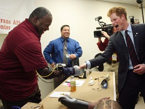 Britain's Prince Harry (R) greets U.S. Army Sgt. Paul Yarbrough (L), as Yarbrough demonstrates his DEKA robotic hand during a tour of the prosthetics lab at the Veterans Administration Harbor Healthcare System in New York in this file photo taken May 29, 2009. The U.S. Food and Drug Administration on Friday said has approved the sale of the DEKA Arm System after reviewing data, including a U.S. Department of Veterans Affairs study, in which 90 percent of people who used the device were able to perform complex activities. 

REUTERS/Mary Altaffer/Pool