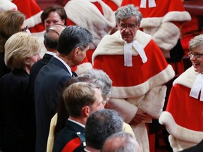 Supreme Court of Canada Chief Justice Beverley McLachlin, right, and Justice Louis LeBel leave the Senate chamber following the Speech from the Throne on Parliament Hill in Ottawa in this October 16, 2013 file photo. (REUTERS/Blair Gable)