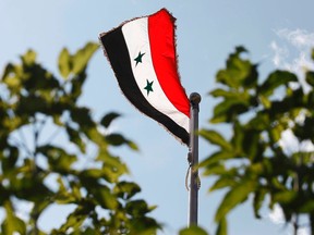 The national flag of Syria is photographed outside the Syrian Embassy in Ottawa, May 29, 2012. (Chris Roussakis/QMI Agency)