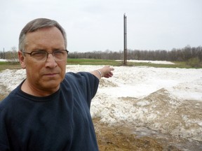 Paul Schliesmann/Postmedia Network
Former Westport Mayor Dan Grunig points to piles of snow and one of the blowers that are used in the village's snowblowing sewage treatment system in this file photo.