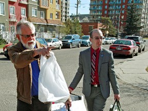 Edmonton City Councillor Ward 1 Andrew Knack (right) and Meals of Wheels volunteer and board of director Vincent Campbell leave the Edmonton Meals on Wheels office to deliver food on Friday May 9, 2014. Each female client received a flower in celebration of Mother's Day with their meal as a token of gratitude for their contribution to our community. Tom Braid/Edmonton Sun