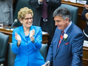 Liberal Premier Kathleen Wynne applauds Finance Minister Charles Sousa as he announces the provincial budget at Queen’s Park on May 1, 2014. (Ernest Doroszuk/Toronto Sun)