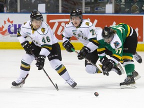 Team White forward Chris Tierney, middle, goes airborne as he and fellow Team White forward Matt Rupert, left, keep the puck away from Team Green forward Tristen Elie during an intrasquad game at Budweiser Gardens on Friday. (CRAIG GLOVER, The London Free Press)