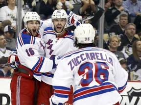New York Rangers center Derick Brassard (16) celebrates scoring a goal against the Pittsburgh Penguins along with left wing Benoit Pouliot (67) and right wing Mats Zuccarello (36) during the first period in game five of the second round of the 2014 Stanley Cup Playoffs at the CONSOL Energy Center on May 9, 2014 in Pittsburgh, PA, USA. (Charles LeClaire/USA TODAY Sports)