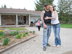 White pride supporters Jared Gilkes and his wife Stefania Goulden stand in the driveway of their home east of London. The couple will play host to a large group of friends for a birthday party for the 38-year-old Gilkes on May 17 that has anti-racism activists and police worried. (CRAIG GLOVER, The London Free Press)