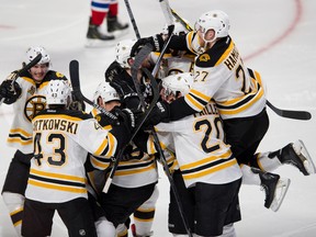 Matt Fraser is in that pile of players somewhere, we promise. The Bruins overtime hero in Game 4 is just the latest example of a young Boston player delivering on a big stage. (QMI AGENCY/PHOTO)
