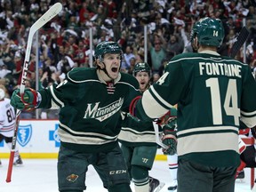 Wild forward Justin Fontaine (14) celebrates his goal with Erik Haula (56) during first period playoff action against the Blackhawks in Game 4 of their series in St. Paul, Minn., on Friday, May 9, 2014. (Brace Hemmelgarn/USA TODAY Sports)