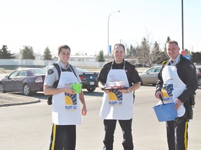 From left. RCMP const. Ian Paddick, Whitecourt Fire Department deputy chief Aaron Floyd an RCMP const. Chris Penney hand out fruit smoothies and collect donations from the Hilltop McDonalds during the morning rush at the drive-thru durng McHappy Days.
Barry Kerton | Whitecourt Star