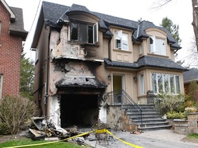 At least nine cars and one house in Moore Park were set ablaze by an arsonist early Friday. The flames spread from one burning car, parked in this driveway on Burnham Rd., causing extensive damage to the home. CHRIS DOUCETTE/TORONTO SUN