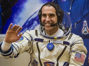 International Space Station (ISS) crew member NASA astronaut Rick Mastracchio waves after donning a space suit shortly before the blast off for the ISS, at the Baikonur cosmodrome in this November 7, 2013 file photo. (REUTERS/Shamil Zhumatov)