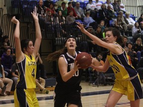 Sudbury Jam's Kristen Ferguson splits a pair of Cornwall United Lions defenders on her way to the hoop during the U17 OBA Ontario Cup Division I semifinal at Laurentian University on Saturday night.