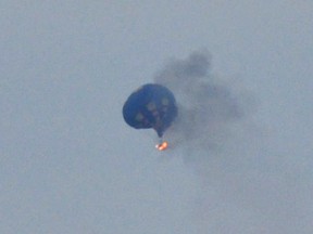 A hot air balloon on fire is pictured north of Richmond, Virginia, May 9, 2014, in this handout photo courtesy of Lynn Shultz. (REUTERS/Lynn Shultz/Handout via Reuters)