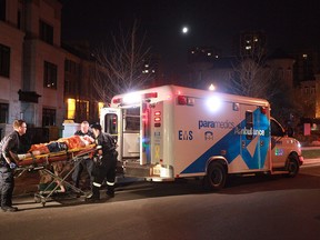 Paramedics aid a man stabbed just after 2 a.m. Sunday, May 11, 2014, on Harrison Garden Blvd., in the Yonge St. and Hwy. 401 area. (John Hanley photo)