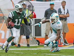 Don Jones of the Miami Dolphins defends against Jeremy Kerley of the New York Jets as he runs with the ball on December 29, 2013 at Sun Life Stadium. (Joel Auerbach/Getty Images/AFP)