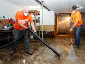 Samaritan's Purse volunteers, Jim Berry, left, and team leader, Mark Yandt, power wash and vacuum water out of Chris Berry's flooded basement at his River Road residence, north of Belleville, Ont. Saturday, May 10, 2014. - Jerome Lessard/The Intelligencer/QMI Agency