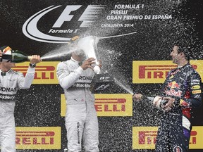 Germany’s Nico Rosberg (left) and Australian Daniel Ricciardo (right) celebrate with Spanish Grand Prix winner Lewis Hamilton of England on Sunday near Barcelona. (AFP/PHOTO)