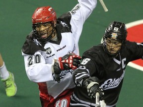 Roughnecks’ Travis Cornwall Doges Rush's Chris Corbeil during the first game of the NLL West semifinal Saturday in Calgary. (Mike Drew, QMI Agency)