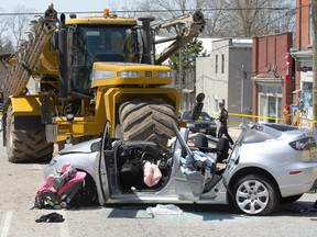 A girl, nine, was killed Sunday morning when the car in which she was a passenger collided with a fertilizer sprayer on Main St. in Otterville. (DEREK RUTTAN, The London Free Press)