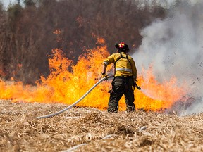 AESRD fire attack crews, along with the Whitecourt Fire Department, battled a stubborn wildfire northeast of Whitecourt on Sunday, May 11. The fire grew to three hectares in size, and took crews several hours to bring under control. Christopher King photo | Whitecourt Star