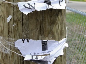 The remains of a poster on Wednesday, May 7, that had been taped to a utility pole on Earl Street at Barrie Street, promoting the Southern Ontario Skinheads. (Julia McKay/Kingston Whig-Standard)